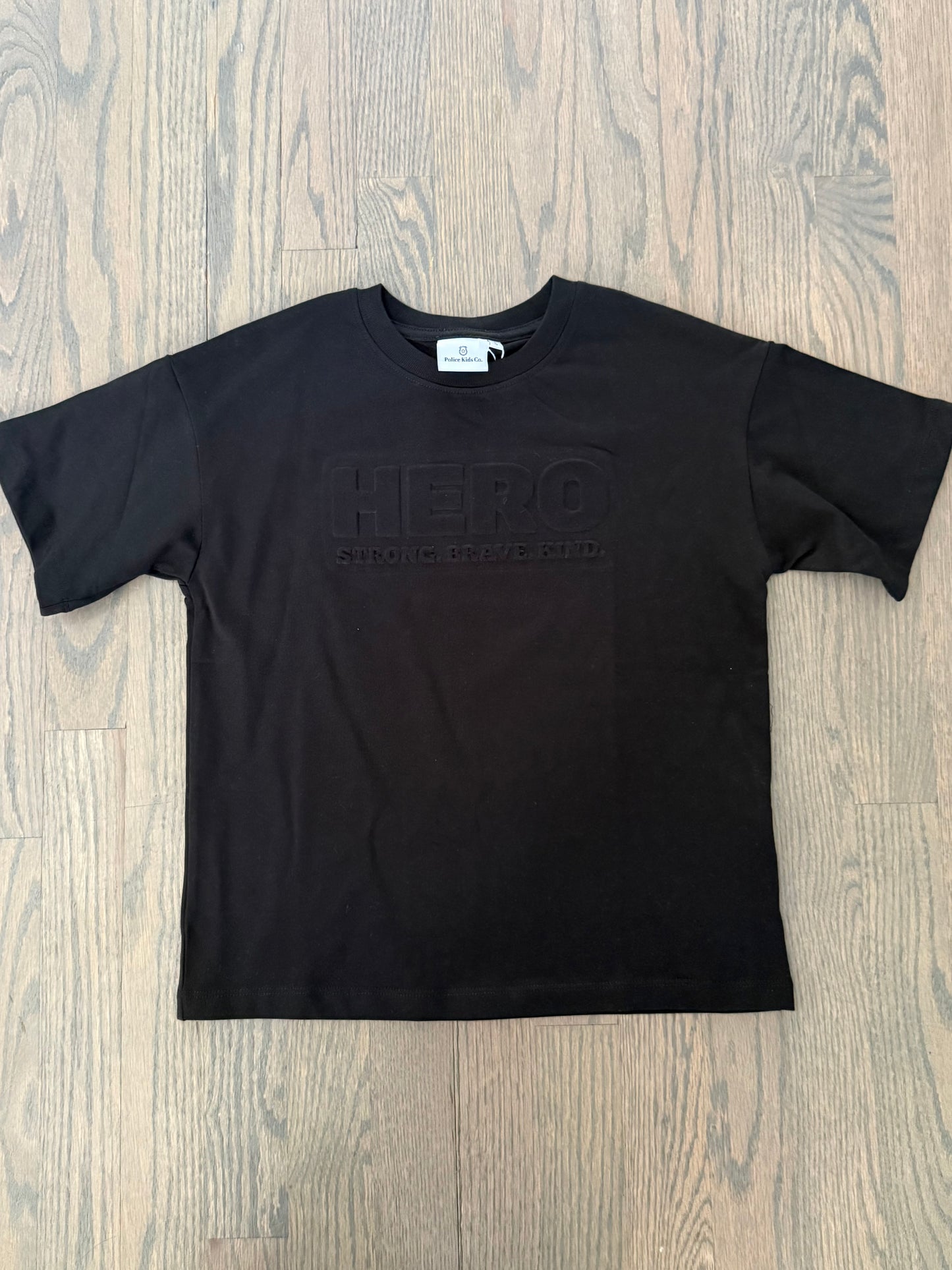 “Raised to Be a Hero” Embossed Tee